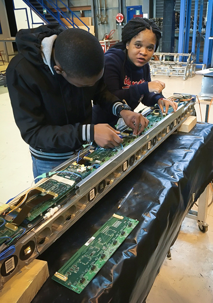 Ntabiseng Lekalakala and a fellow student working on electronic equipment
